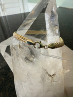 Yellow gold woven mesh bracelet with decorative clasp and linked square mesh band