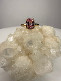 14k yellow gold ring close-up with cushion-cut pink sapphire, four prongs