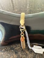 Yellow gold woven mesh bracelet with toggle-style clasp and linked mesh band
