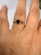 14k yellow gold ring with deep red round garnet and thin band, size 6