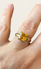 14k yellow gold princess-cut yellow sapphire ring worn on finger, square yellow stone