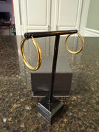14k yellow gold round hoop earrings side view on display stand