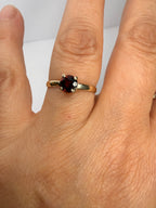 14k yellow gold ring with deep red round garnet center stone, size 6