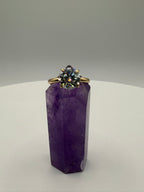 Yellow gold ring with round halo center stone and thin band, front view