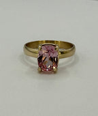 14k yellow gold ring with pink oval sapphire center, straight on