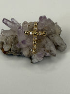 Gold diamond cross pendant centered on druzy crystal cluster