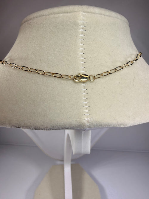 10k gold chain necklace with a lobster clasp, displayed on a cream-colored velvet jewelry bust.