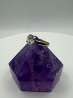 Round moissanite solitaire engagement ring in 14k yellow gold, side view