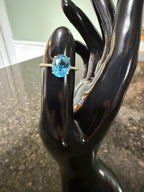 Oval blue topaz gemstone in 10k yellow gold prong-set ring with slim band