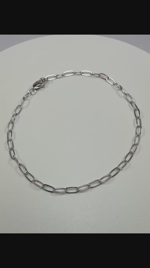 Close up detail of 10k white gold 2.1mm paperclip links showing high polish finish and lobster clasp