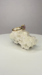 14k yellow gold ring close-up with cushion-cut pink sapphire, four prongs