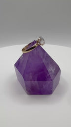 14k yellow gold moissanite ring featuring a round center stone