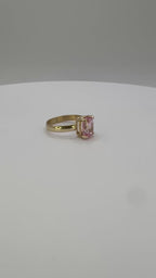 14k yellow gold ring with pink oval sapphire center, straight on