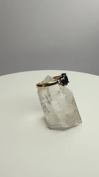 14k yellow gold ring with round dark blue sapphire on clear crystal base