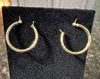 Textured 10k solid gold round hoop earrings with latch backs, close view